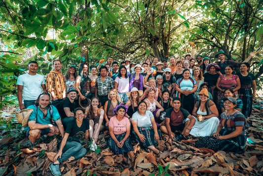 Homecoming participants with Keith's Cacao workers in the cacao forest in Guatemala